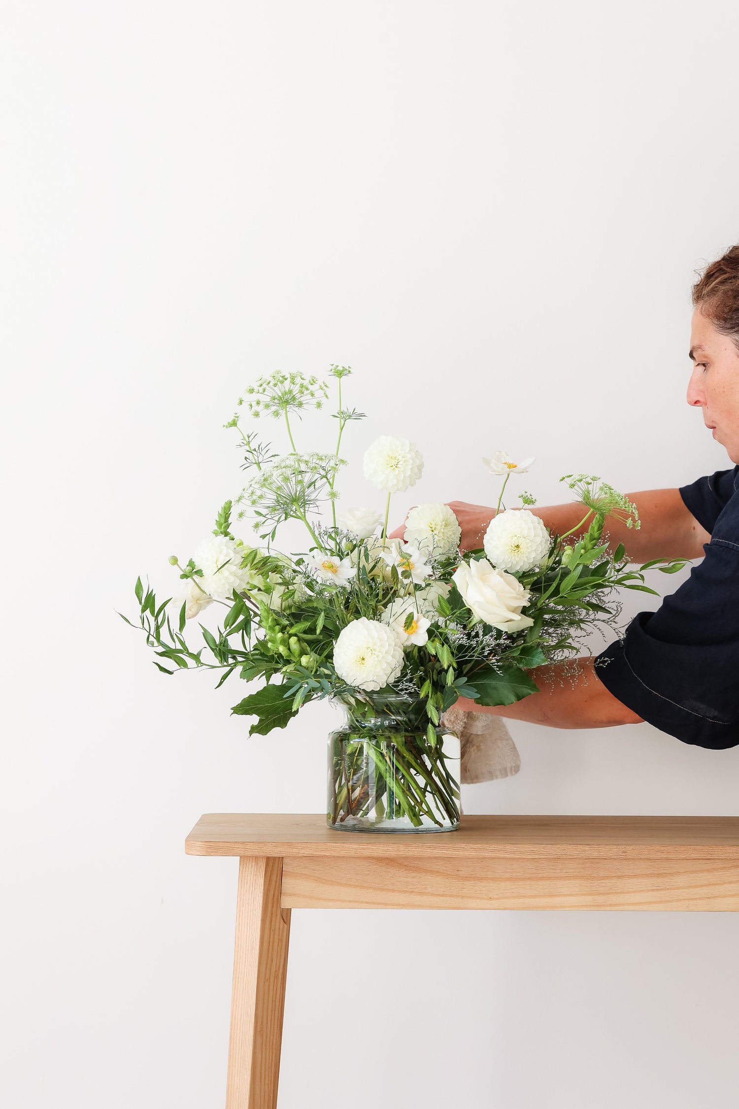 A bouquet of white flowers and green foliage