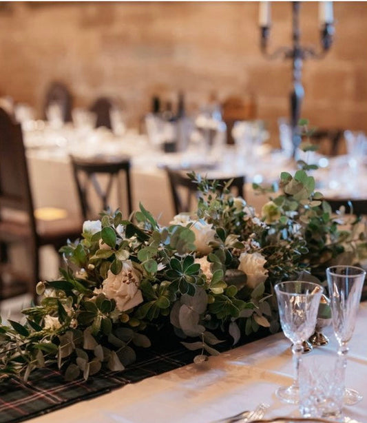 Wedding couple with flowers at Borthwick Castle