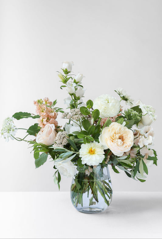 Bouquet of flowers in a clear vase on a white background