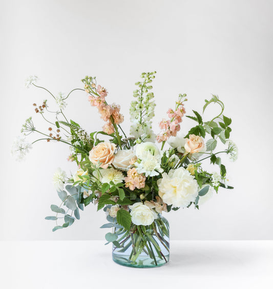 Bouquet of flowers in a clear vase on a white background