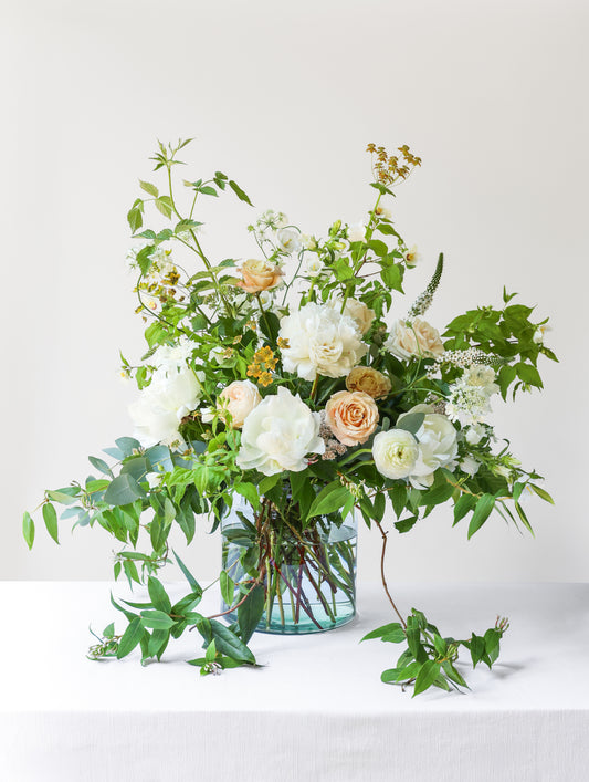 Floral arrangement in a clear vase on a white background
